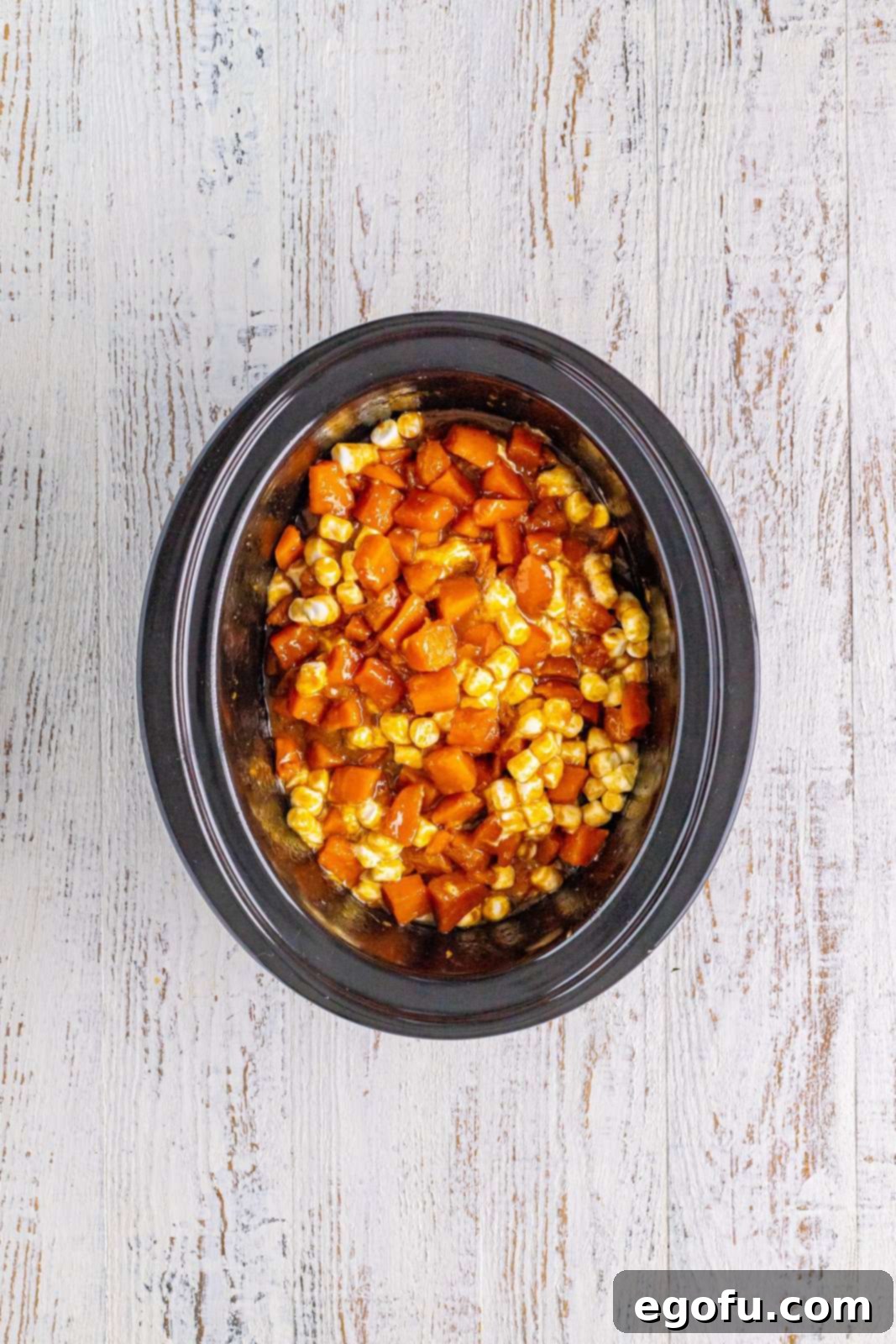 Marshmallows stirred into the sweet potato mixture in the crock pot.