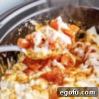 Close up square image of Crock Pot Sweet Potato Casserole on serving spoon.