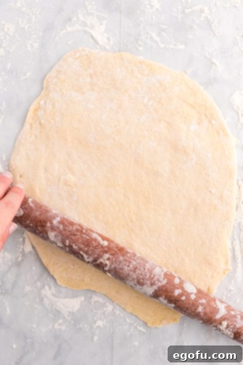 Dough being rolled out into a circle.