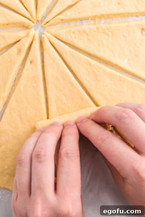 Triangles being rolled up into crescent shapes.