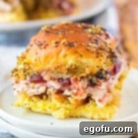 Close up of one of the Thanksgiving Leftovers Sliders on white plate showing layers and glaze on top.