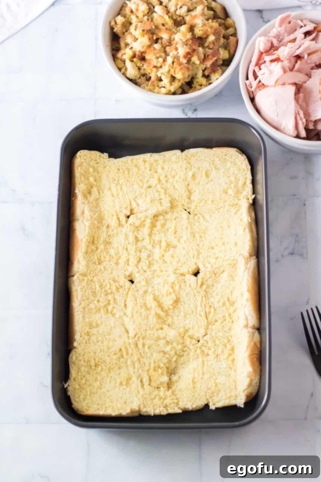 Bottom layer of rolls placed into bottom of baking pan.