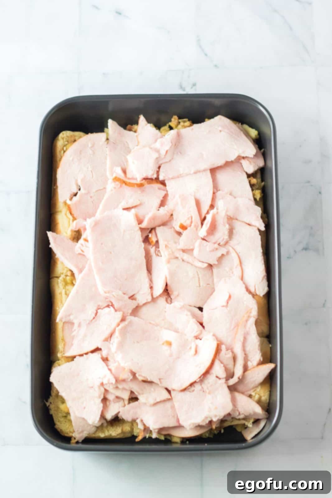 Turkey layered over the top of the stuffing.