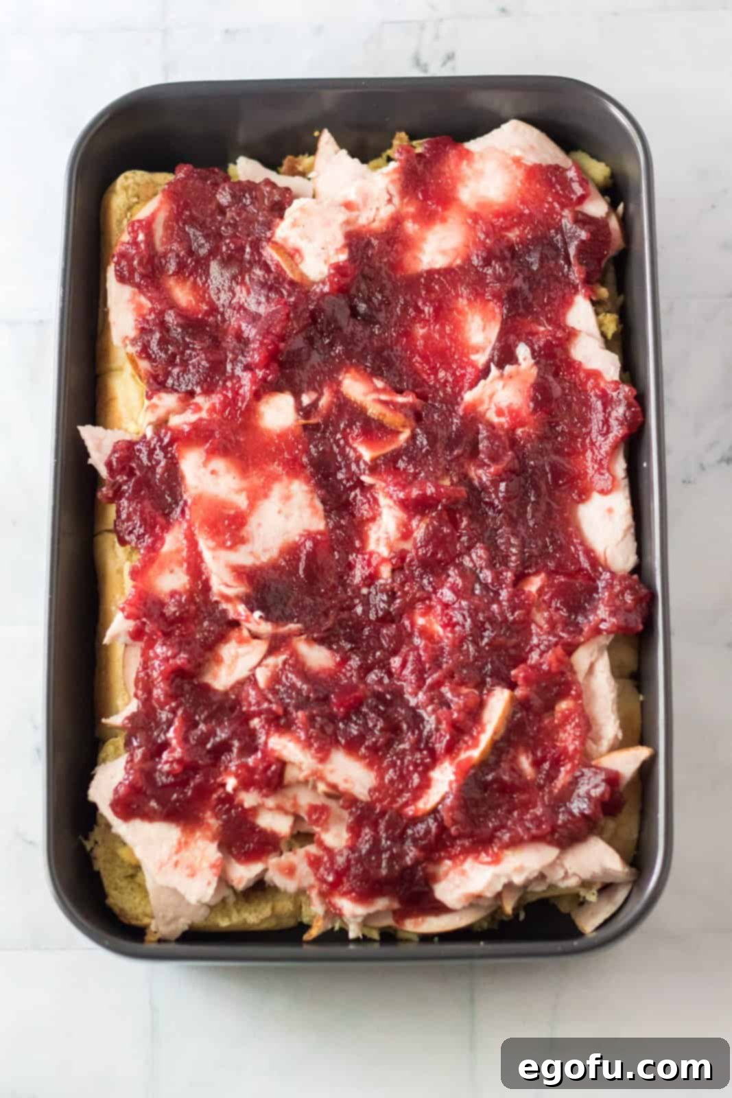 Cranberry sauce spread over the top of the turkey.