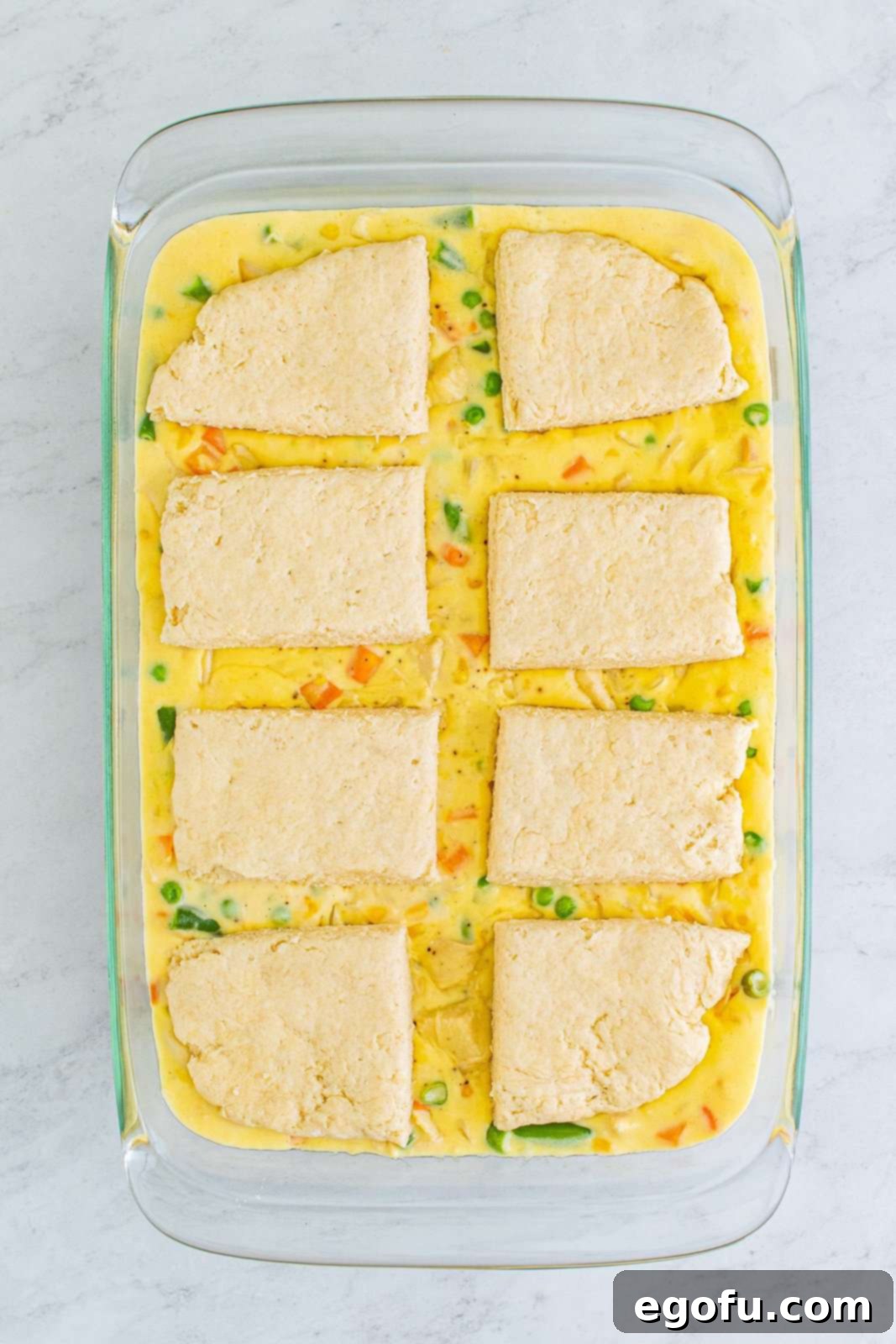 Hearty Turkey Pot Pie Delight 15 Biscuits placed on top of pot pie filling in pan.