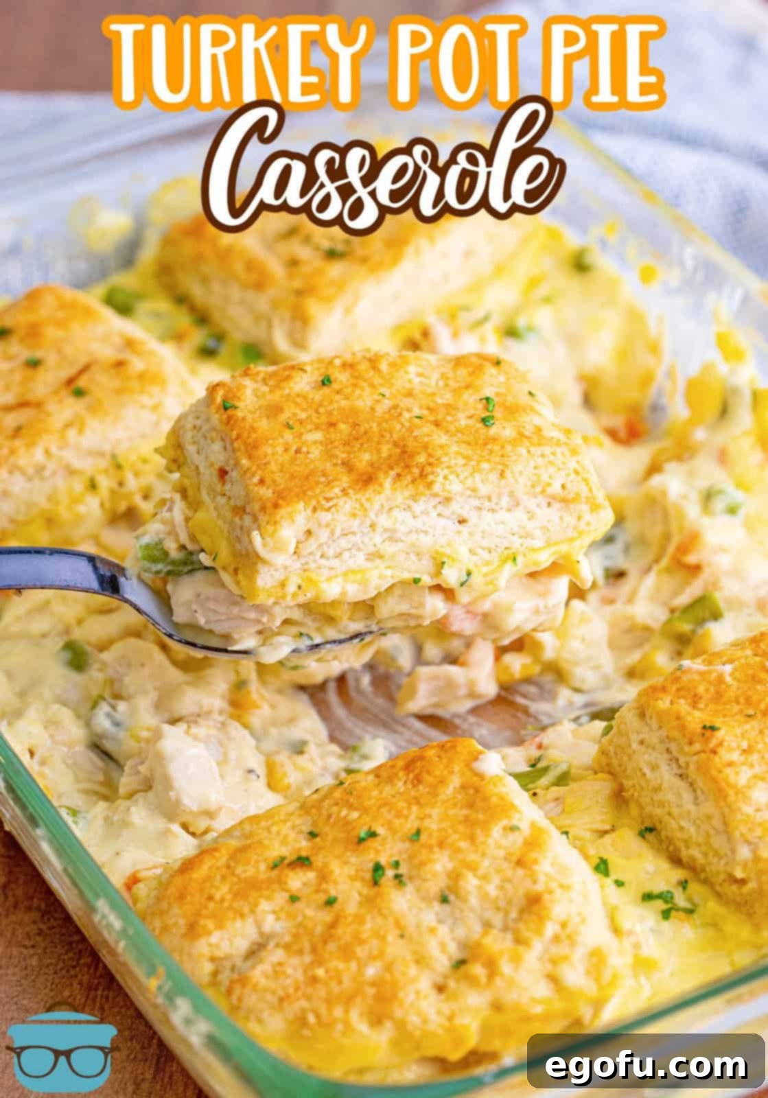 Hearty Turkey Pot Pie Delight 3 Pinterest image of serving spoon scooping out some of the Turkey Pot Pie Casserole from baking dish.