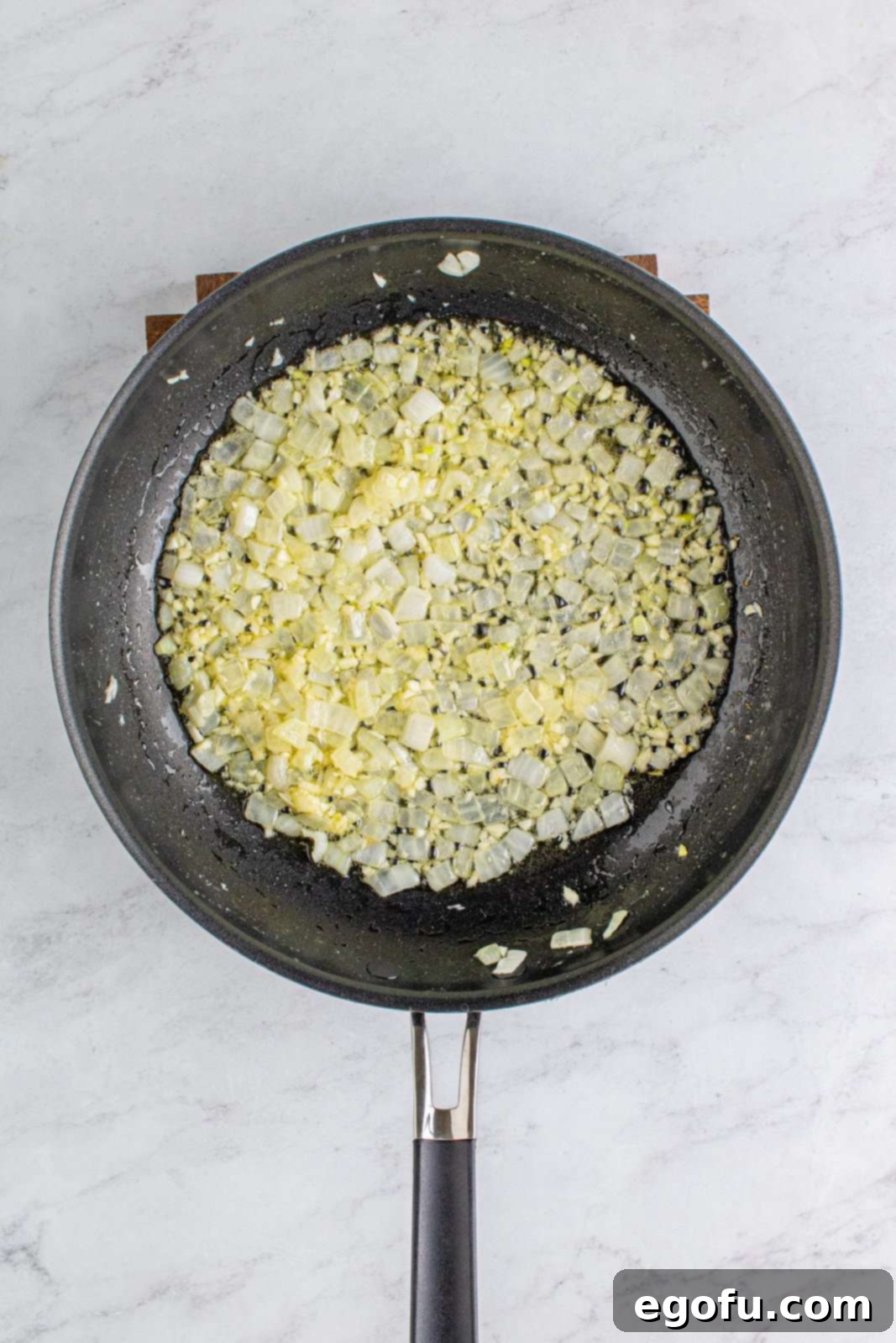Hearty Turkey Pot Pie Delight 5 Butter, onions and garlic sautéing in pan.