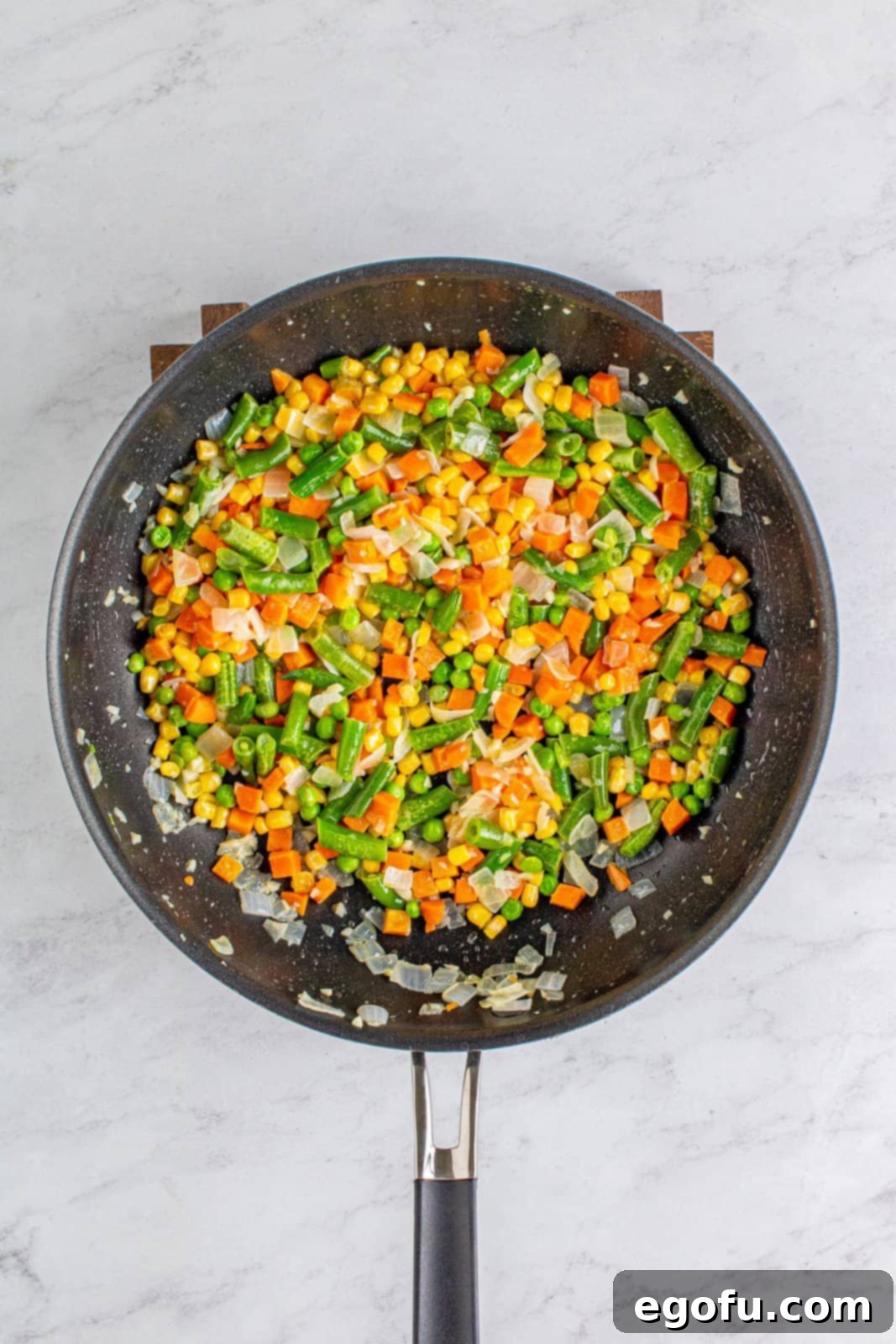 Hearty Turkey Pot Pie Delight 6 Frozen vegetables added to pan.