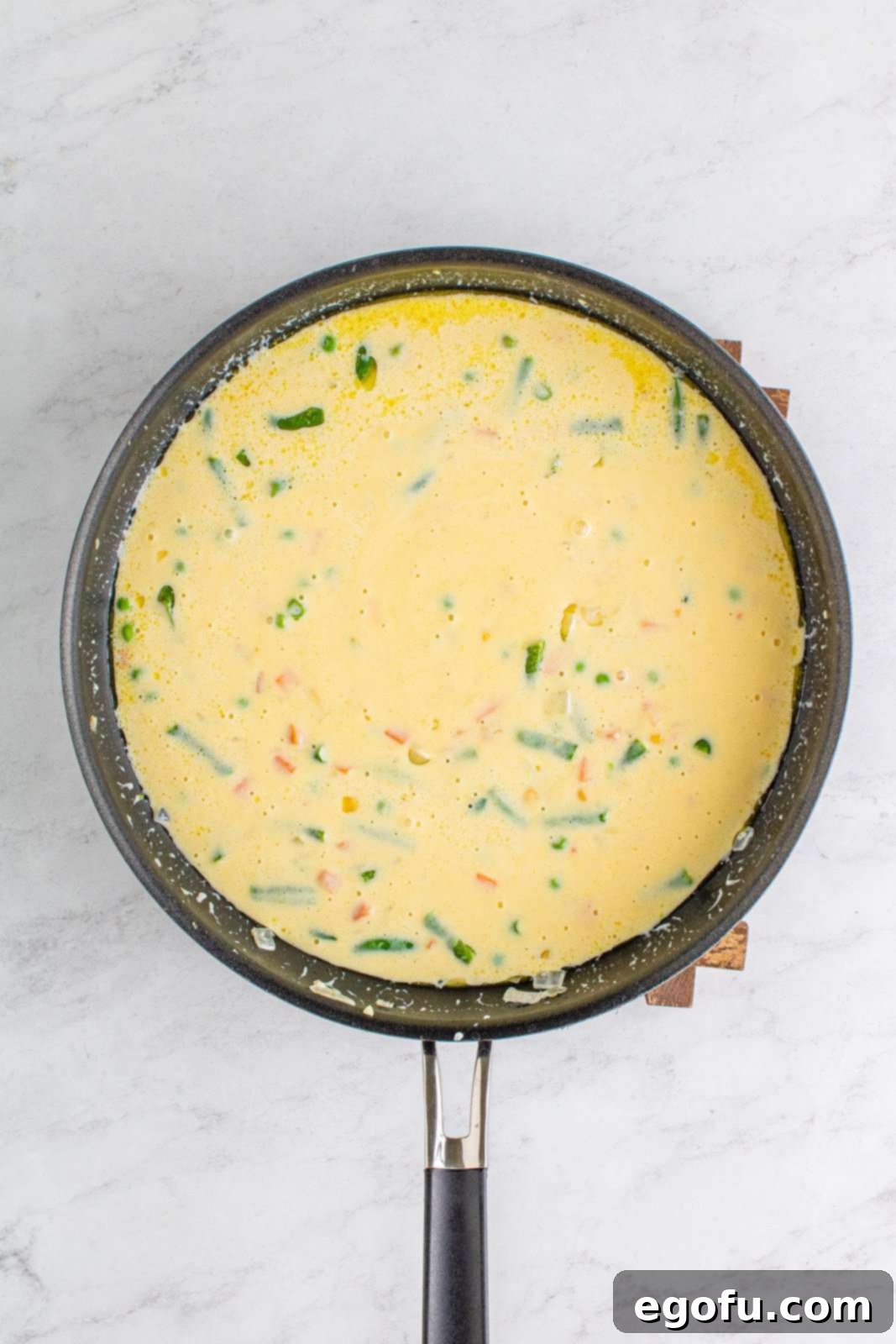 Hearty Turkey Pot Pie Delight 7 Half and half and cream of chicken soup whisked into vegetable mixture in pan.