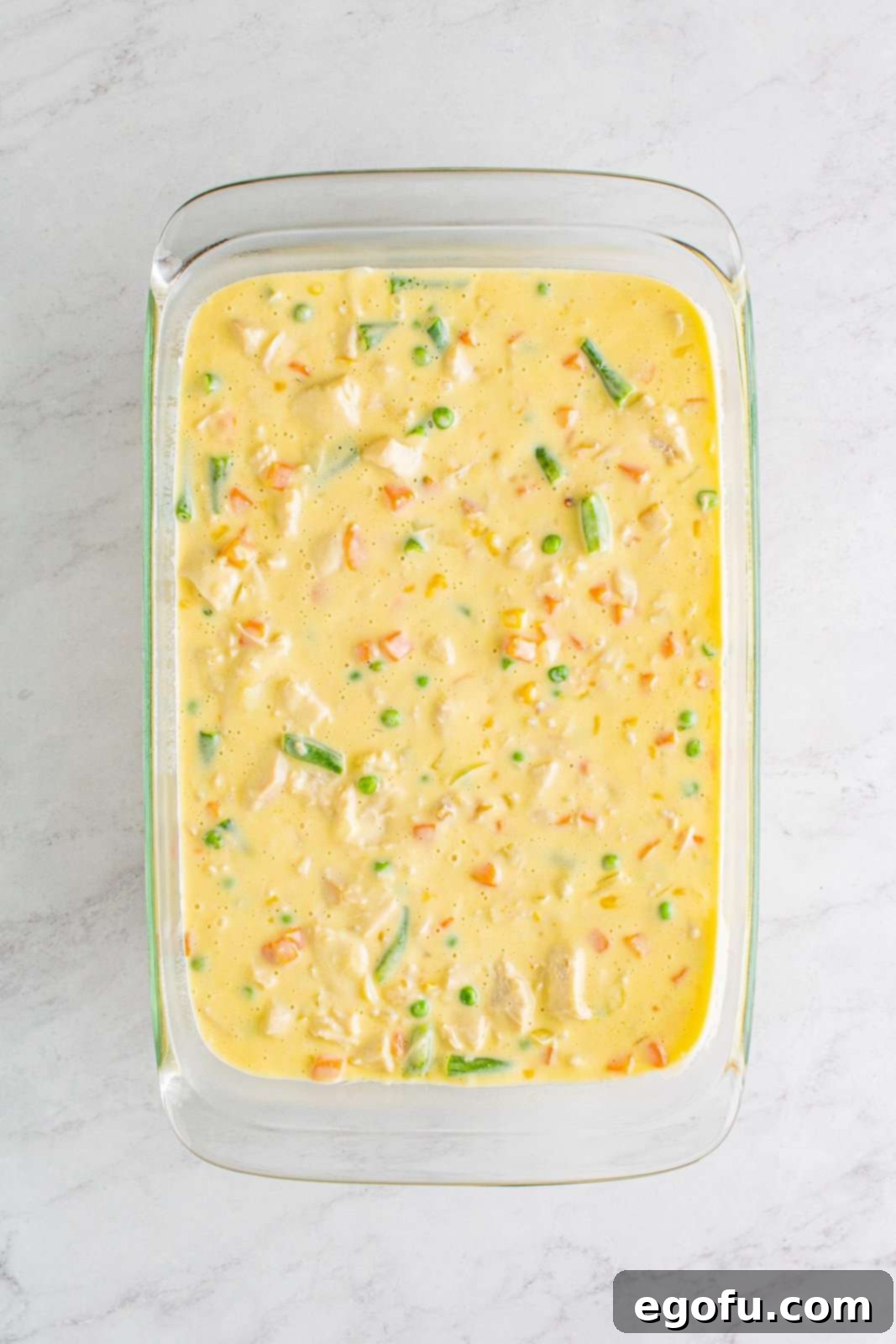 Hearty Turkey Pot Pie Delight 9 Pan mixture added to prepared baking dish.