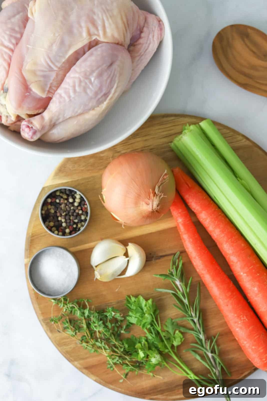 Ingredients needed: whole chicken, celery sticks, carrots, garlic, onion, cooking oil, water, rosemary, thyme, parsley, bay leaf, whole peppercorns and salt.