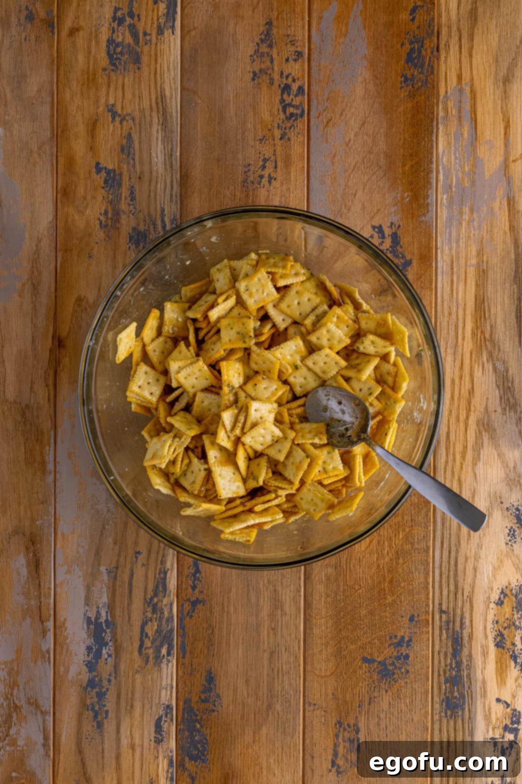 Melted butter mixture poured over crackers and mixed in bowl.