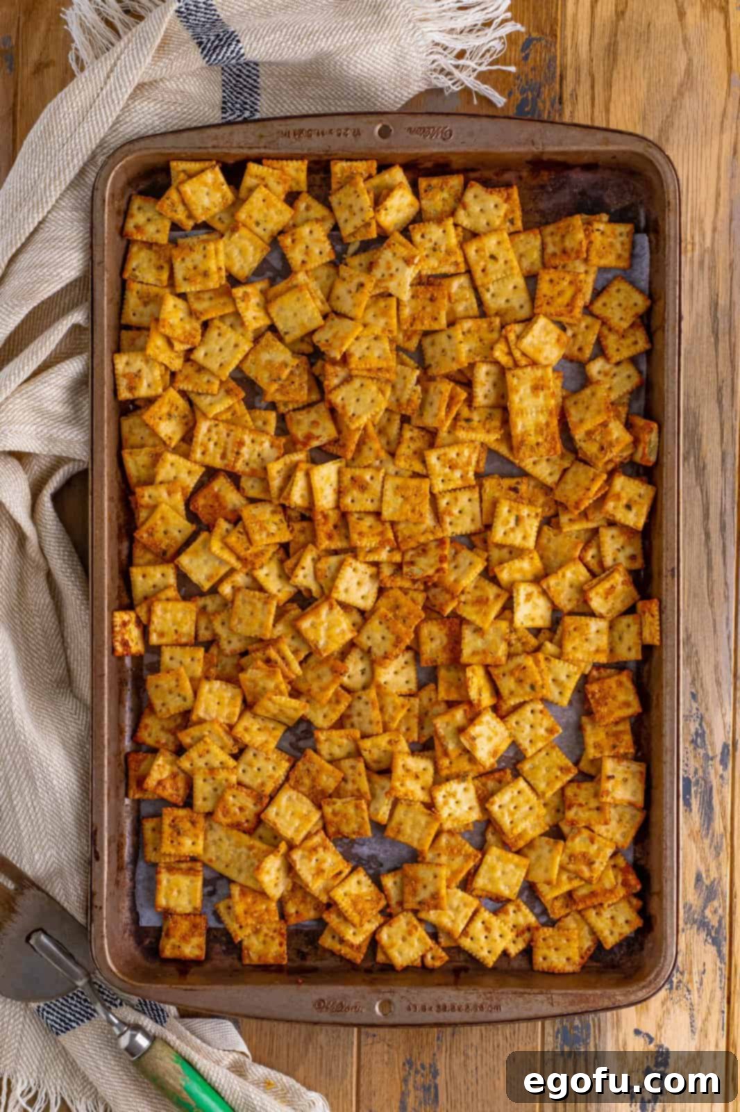 Finished baked crackers on parchment lined baking sheet.