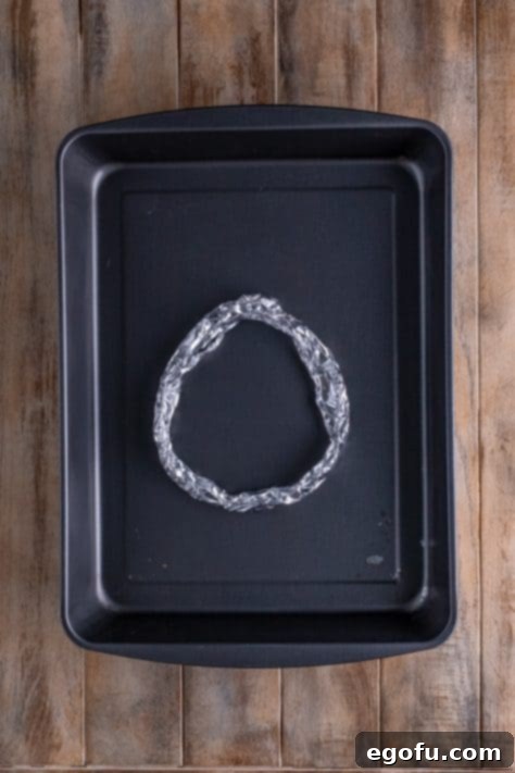 Mahogany Glazed Ham 16 Tin foil ring placed into bottom of baking pan.