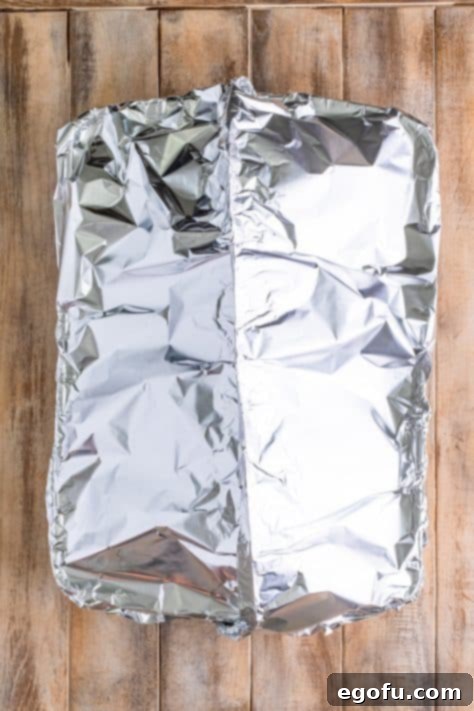 Mahogany Glazed Ham 22 Ham tented with tin foil.