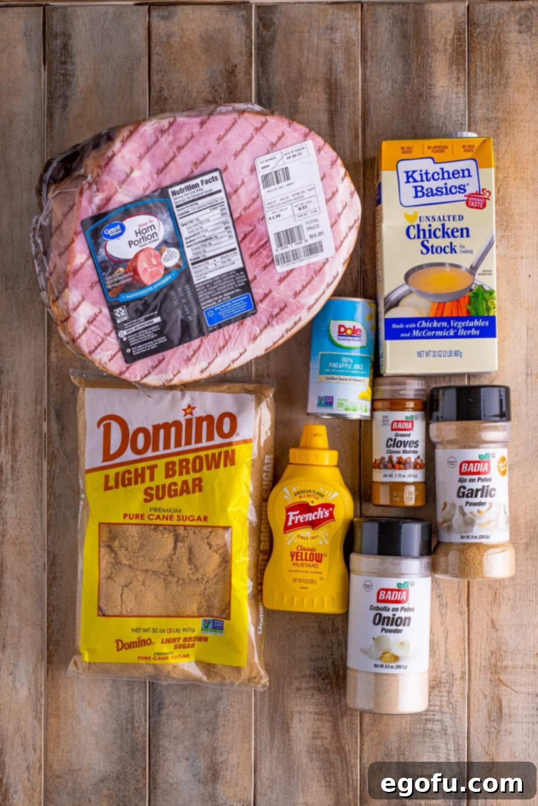 Mahogany Glazed Ham 4 All the ingredients for Brown Sugar Glazed Ham laid out: bone-in ham, unsalted chicken stock, pineapple juice, light brown sugar, yellow mustard, garlic powder, onion powder, and ground cloves.