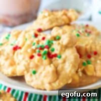 Close up square image of stacked Crock Pot Avalanche Cookies on white plate.
