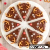 Close up overhead square photo of festive Reindeer Cookie Bars on a white round platter, ready to be enjoyed as a delightful holiday treat.