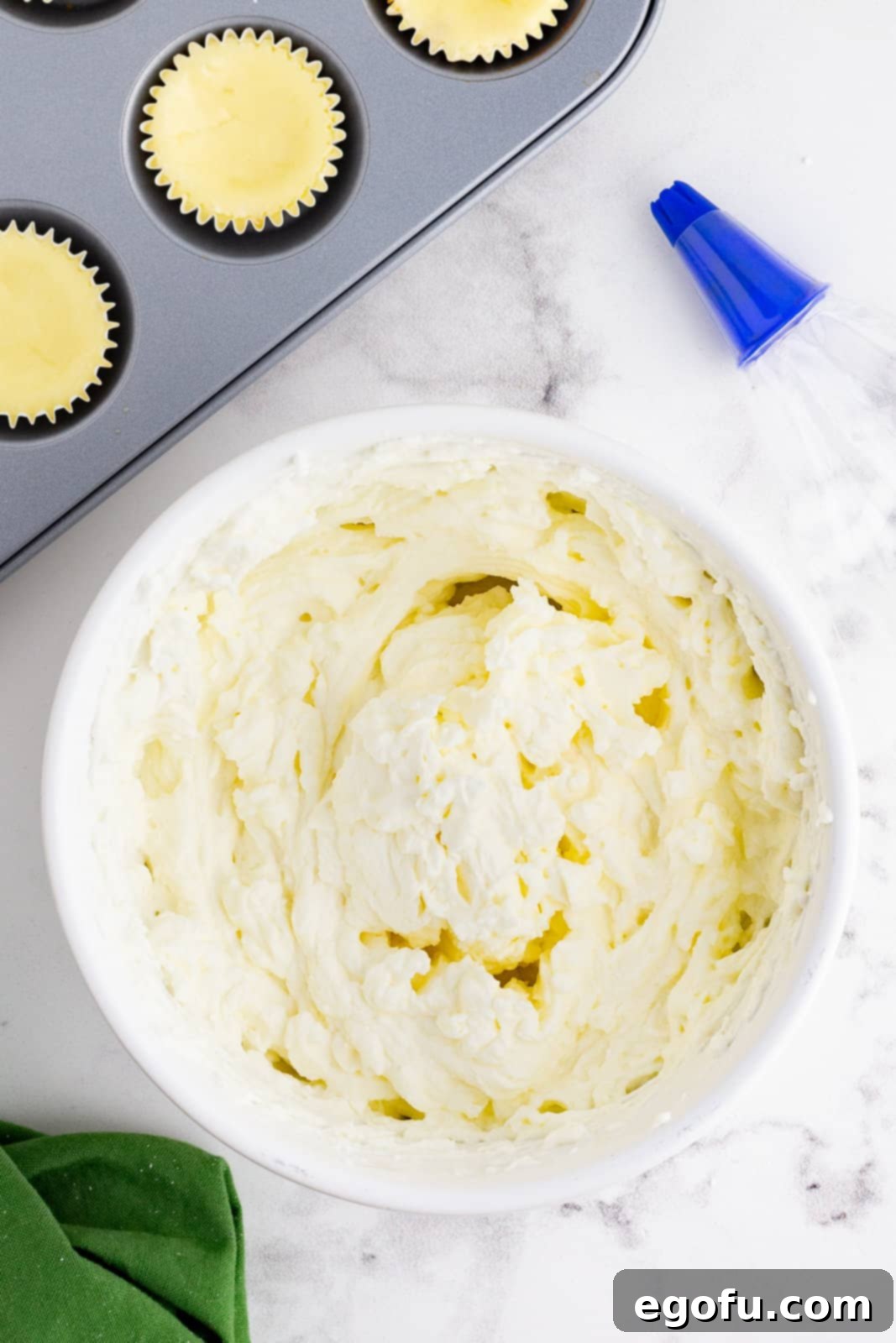 Jolly Santa Hat Cheesecakes 11 Whipped cream beaten together in bowl.