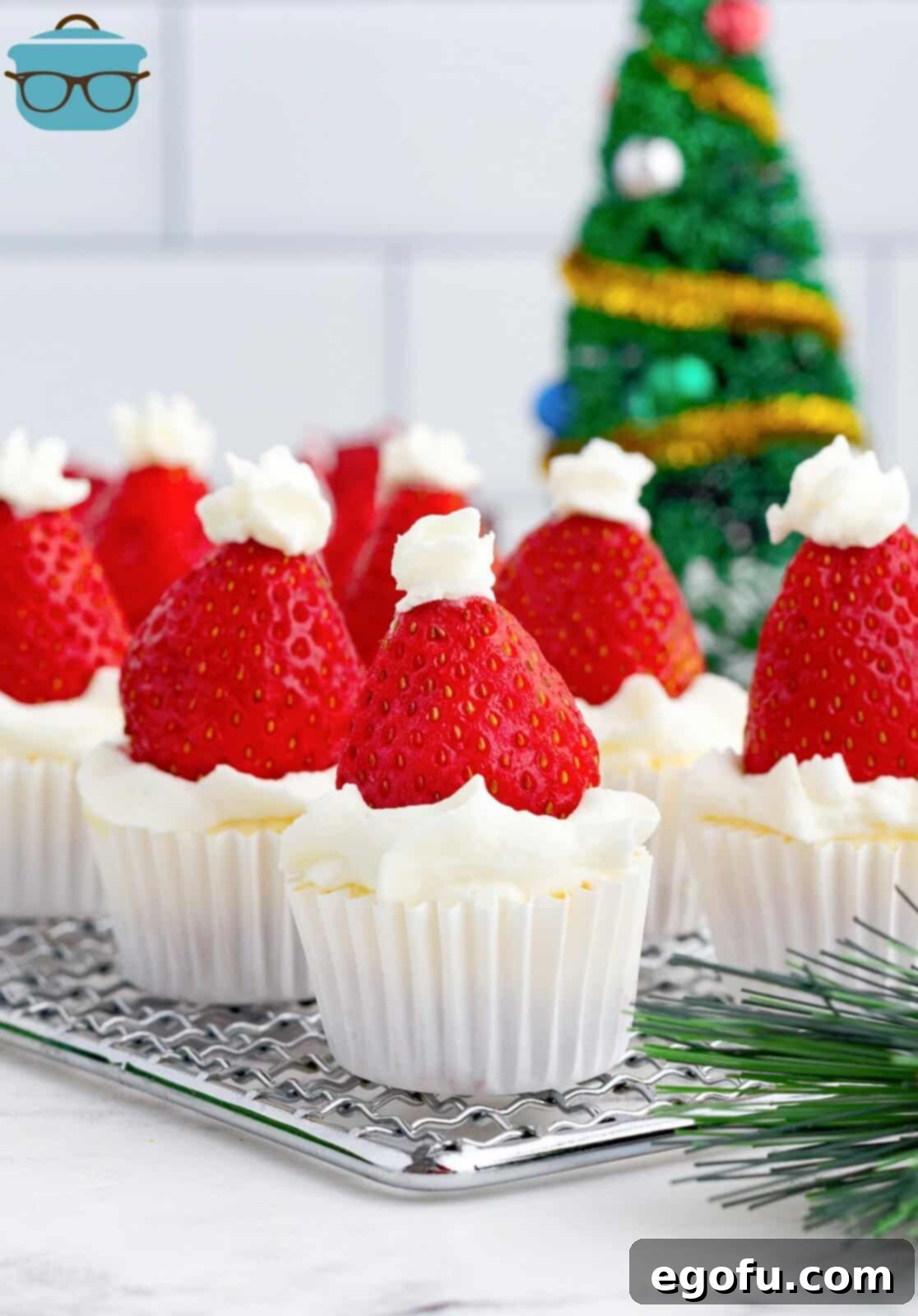 Jolly Santa Hat Cheesecakes 13 Santa Hat Mini Cheesecakes on wire rack.