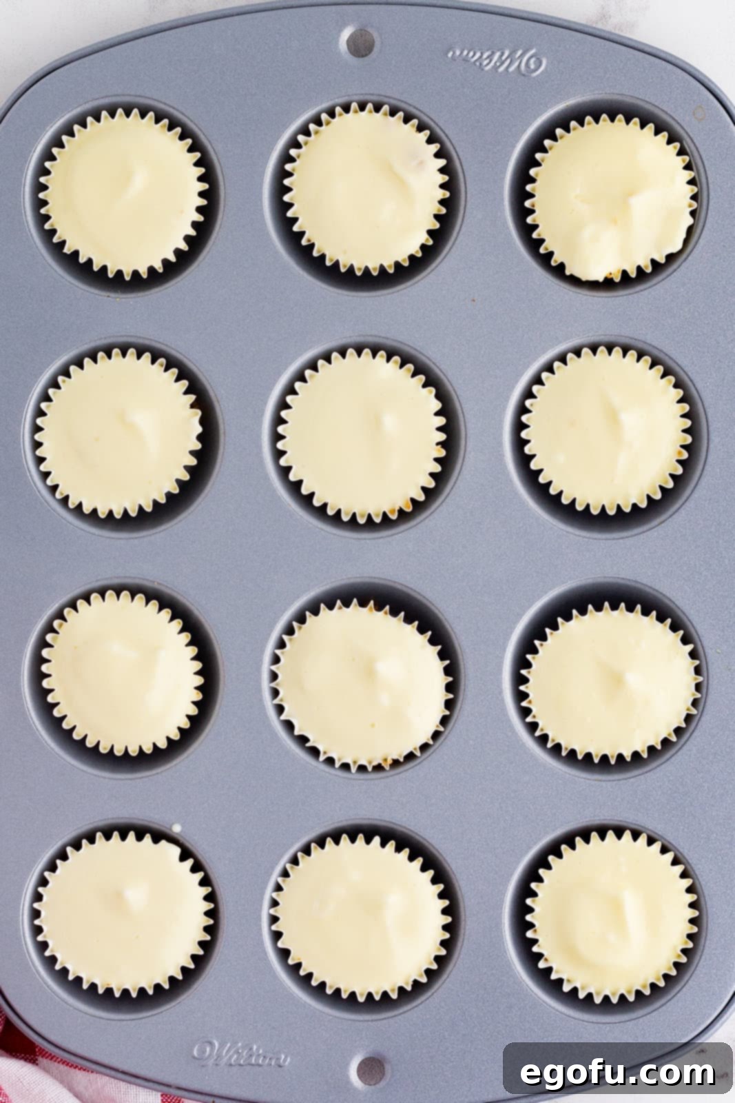 Jolly Santa Hat Cheesecakes 10 Finished mini cheesecakes in pan.