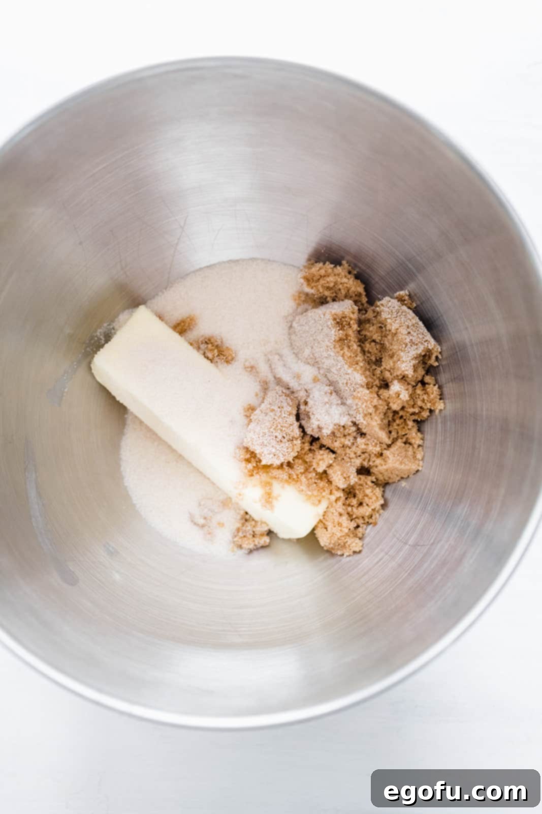 Butter, brown sugar and granulated sugar in bowl of stand mixer.