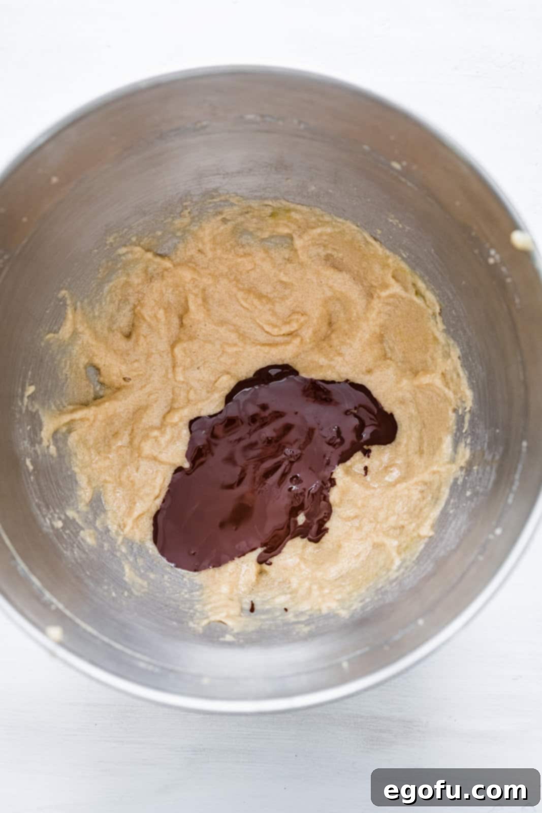 Melted chocolate added to the bowl of the stand mixer.