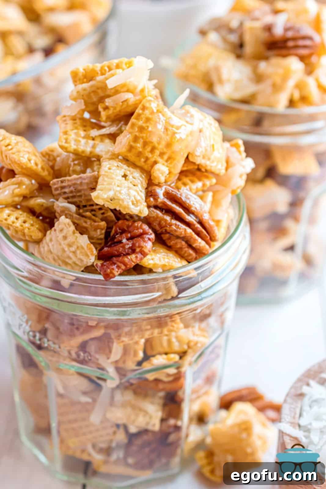 Sweet Holiday Chex Mix in a charming mason jar, ready for gifting or snacking.