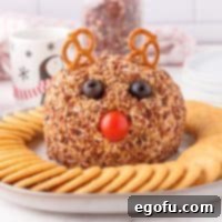 Close up square image of finished Rudolph Cheeseball on platter with crackers.