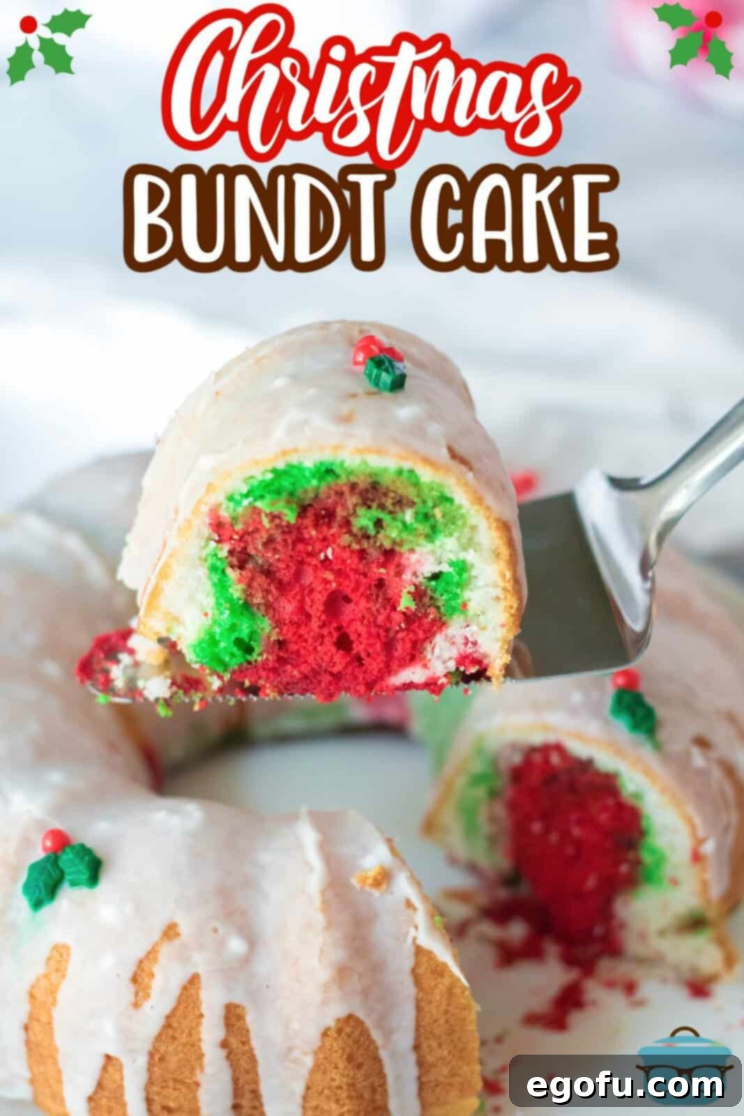 a silver pie server holding up a slice of bundt cake showing the red and green colors inside the cake. 