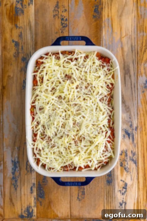 shredded Mozzarella and Parmesan cheese sprinkled evenly over the top of the casserole.