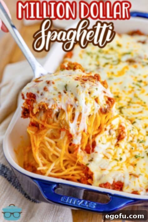 a large silver spoon scooping the spaghetti out of the casserole dish.