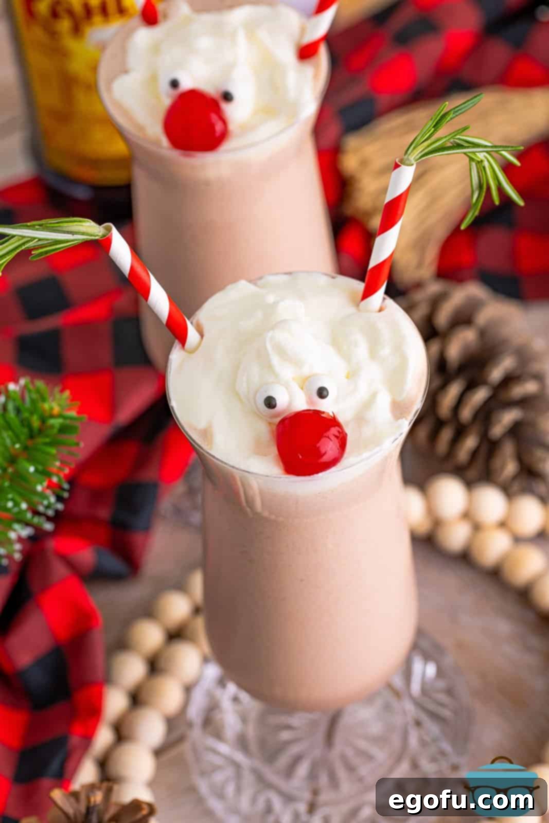 Rudolph on the Rocks 3 An overhead shot of a single Drunken Rudolph milkshake, showcasing its whipped cream topping, cherry nose, and straw antlers against a dark background.