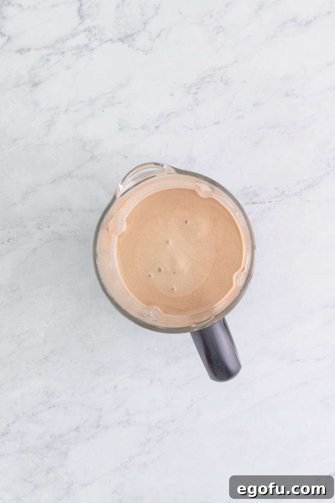 Rudolph on the Rocks 6 An overhead shot of a perfectly blended Drunken Rudolph milkshake inside a blender, showing its smooth, creamy texture.