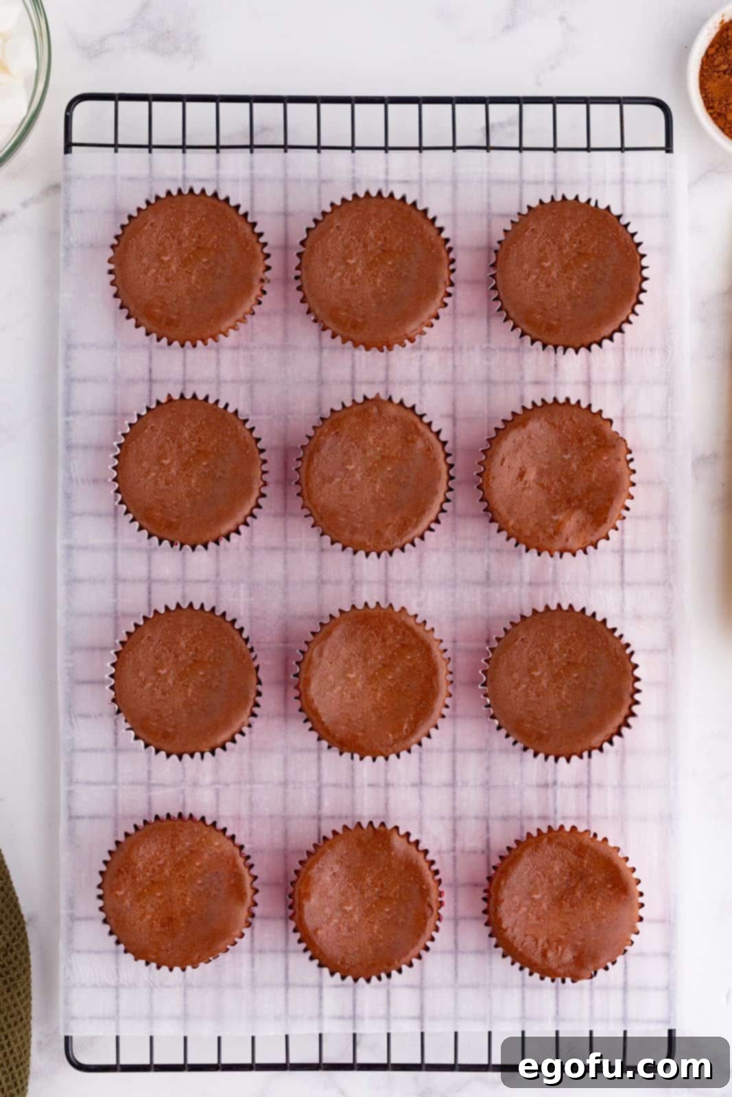 mini chocolate cheesecakes cooling on a wire rack. 
