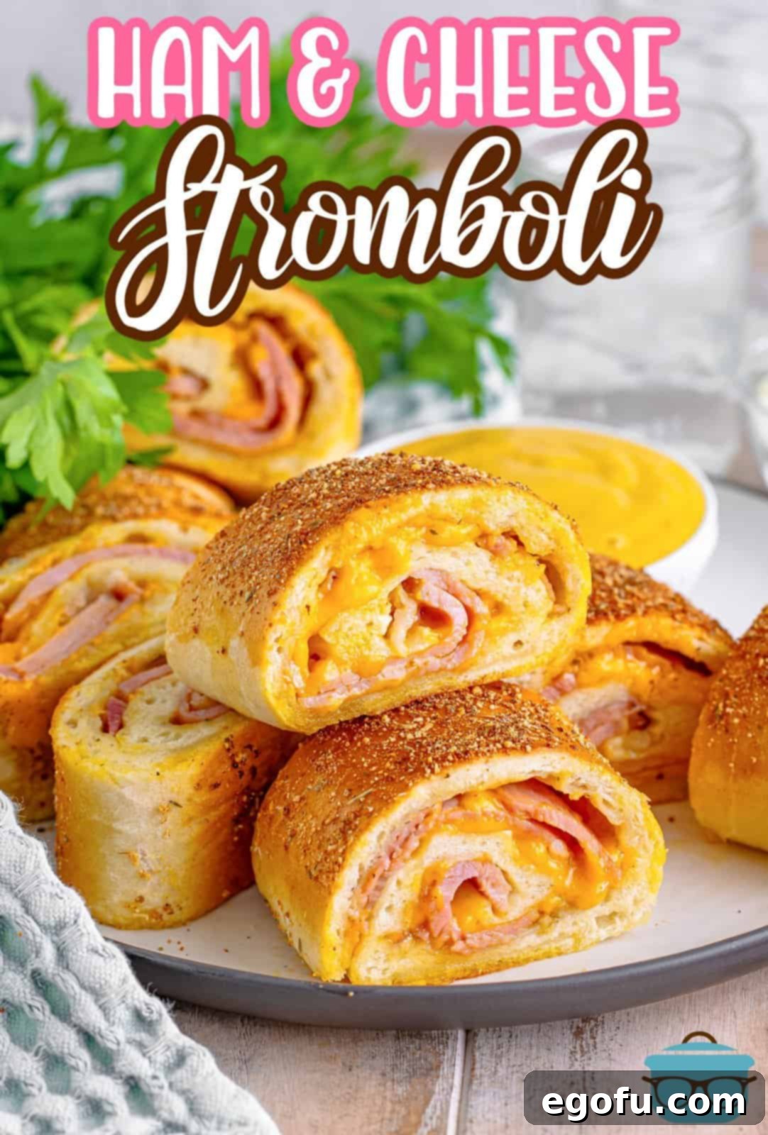 Effortless Ham and Cheese Stromboli Delight 3 slices of ham and cheese Stromboli on a round white plate with some flat leaf parsley in the background.