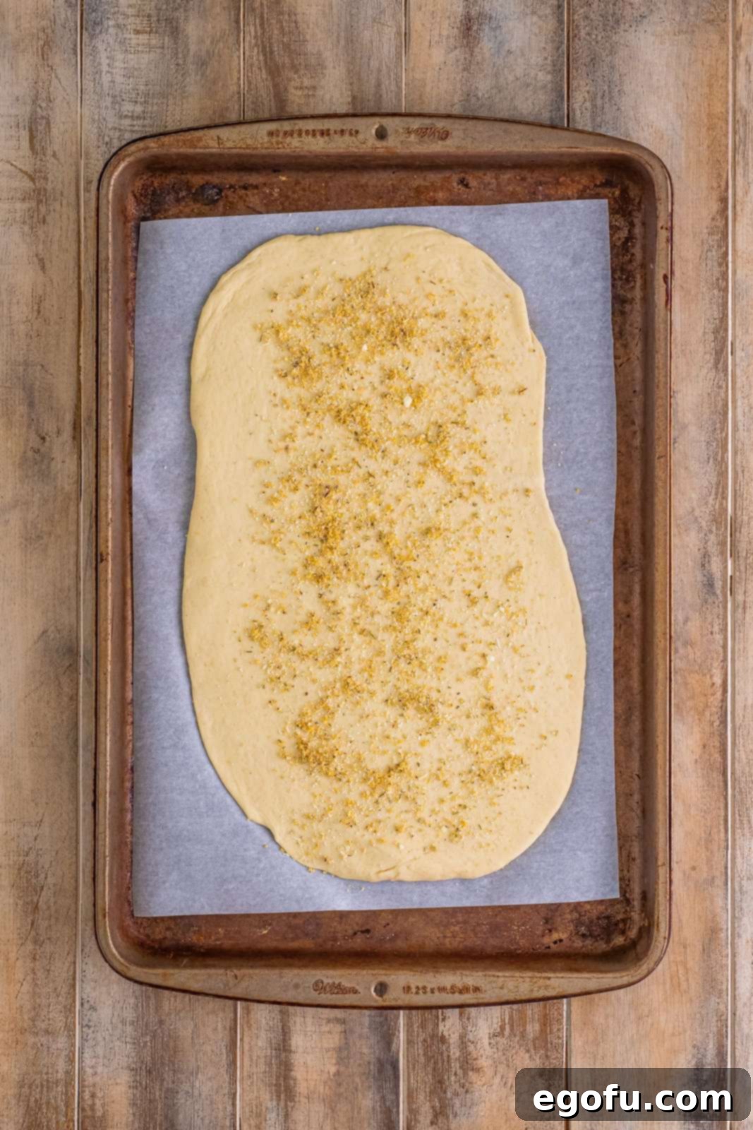 Effortless Ham and Cheese Stromboli Delight 8 Italian seasoning mixture sprinkled evenly on top of pizza dough.