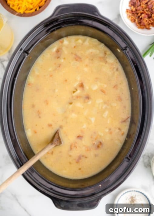 Effortless Slow Cooker Potato Soup with Frozen Potatoes 17 potato soup after it has been cooked for 5 hours shown in the crock pot.