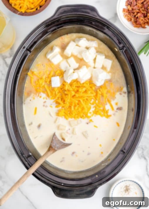 Effortless Slow Cooker Potato Soup with Frozen Potatoes 18 cream cheese and shredded cheddar cheese added to potato soup.