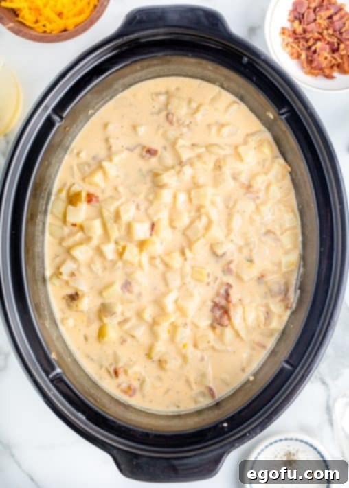 Effortless Slow Cooker Potato Soup with Frozen Potatoes 19 fully cooked potato soup shown overhead in a slow cooker.