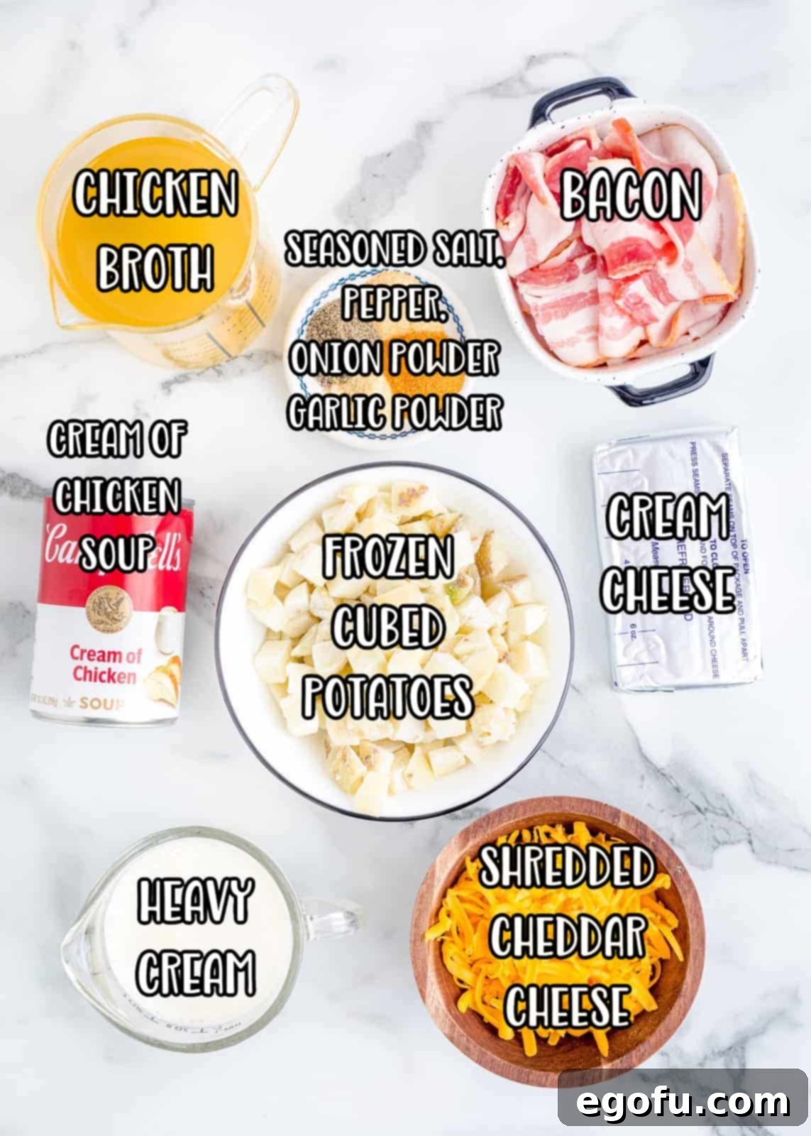 Effortless Slow Cooker Potato Soup with Frozen Potatoes 5 A flat lay photograph showcasing all the ingredients for Slow Cooker Potato Soup: frozen hash brown cubes, cream cheese, cheddar cheese, raw bacon, chicken broth, cream of chicken soup, various seasonings, and a jug of heavy cream.