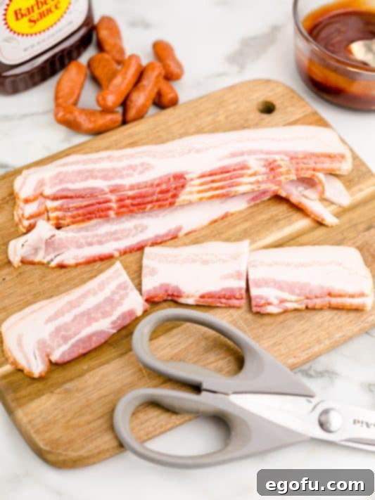 bacon shown cut into three pieces on a cutting board with kitchen scissors.