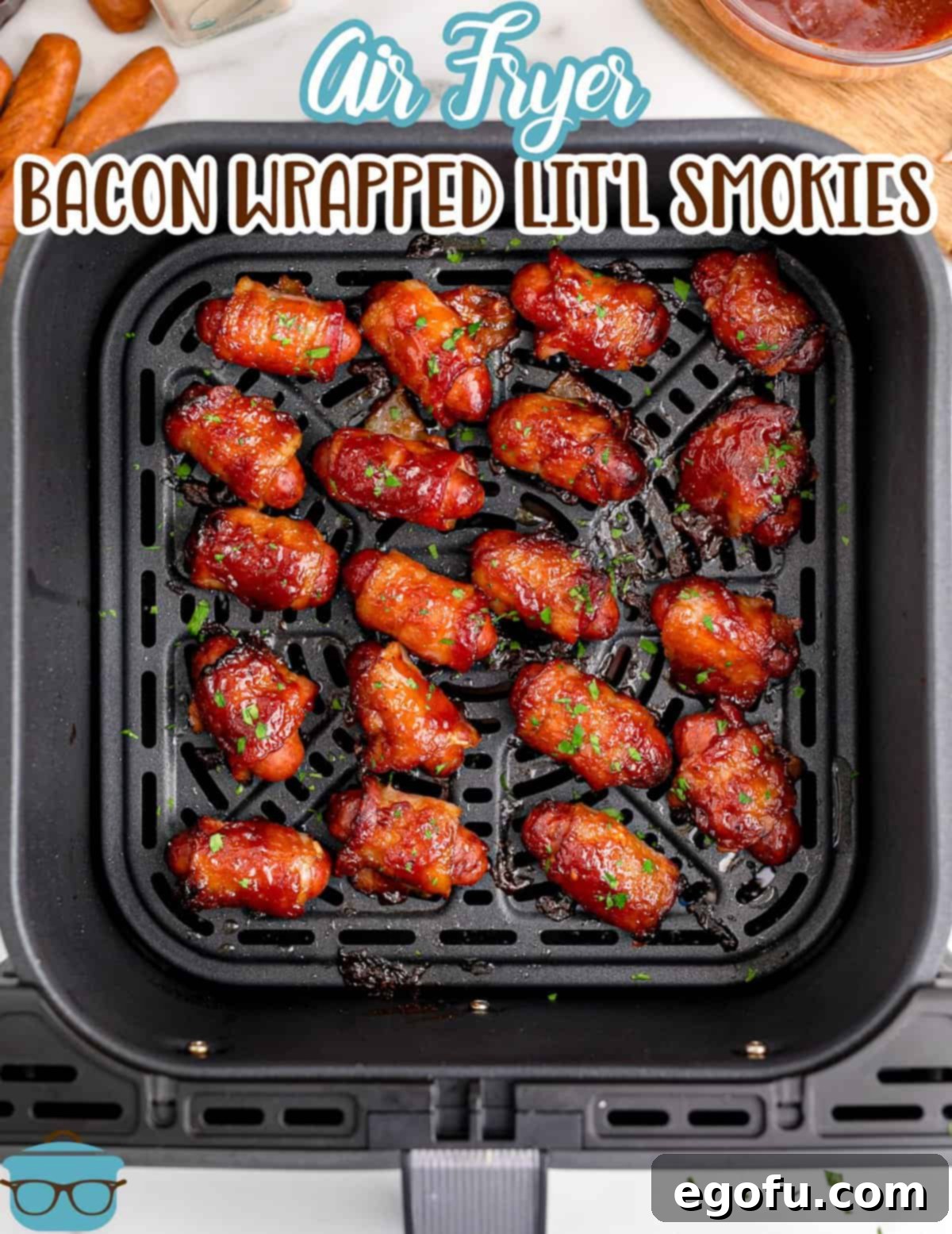 fully cooked bacon wrapped little smokies shown in an air fryer basket.