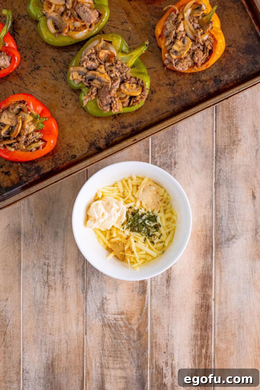 Philly Cheesesteak Pepper Boats 12 shredded Provolone cheese with mayonnaise, onion powder, garlic powder and parsley flakes.