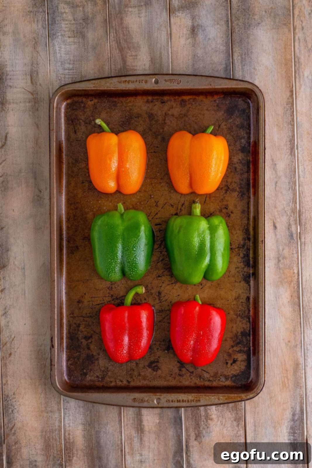 Philly Cheesesteak Pepper Boats 5 6 bell peppers sprayed with nonstick cooking spray on a baking sheet.