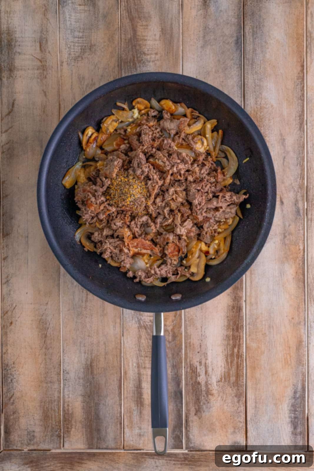 Philly Cheesesteak Pepper Boats 9 seasoning and beef added back to skillet with onions and mushrooms.