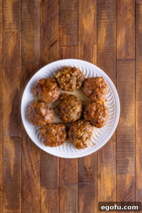 cooked hamburger patties on a round white plate.