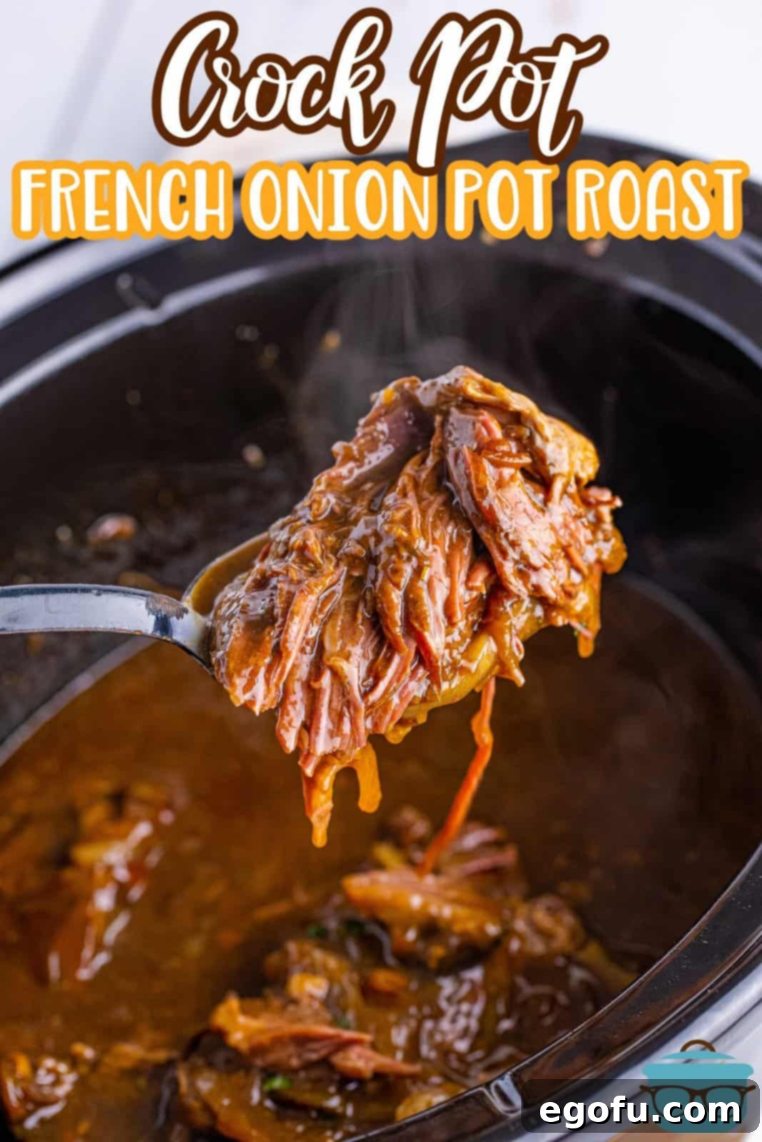 A serving of shredded French Onion Pot Roast being lifted from the slow cooker insert with a serving spoon, highlighting the rich gravy.