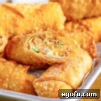 Spicy Creamy Egg Roll Poppers 14 Close up looking at a cut open Egg Roll with Jalapeno popper filling.