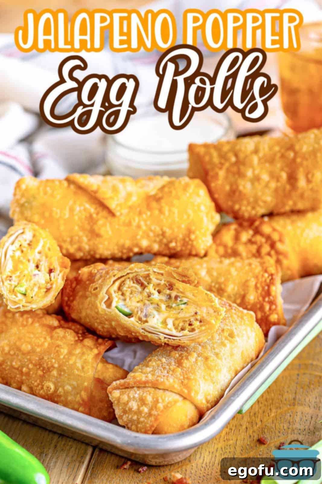 Spicy Creamy Egg Roll Poppers 4 A baking sheet filled with freshly rolled Jalapeno Popper Egg Rolls, ready for frying.